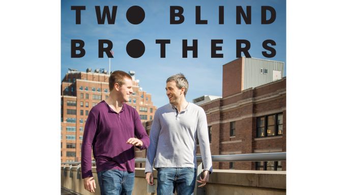 Two Blind Brothers logo (black text with solid o's) over photo of Bradford and Bryan Manning on a sunny day